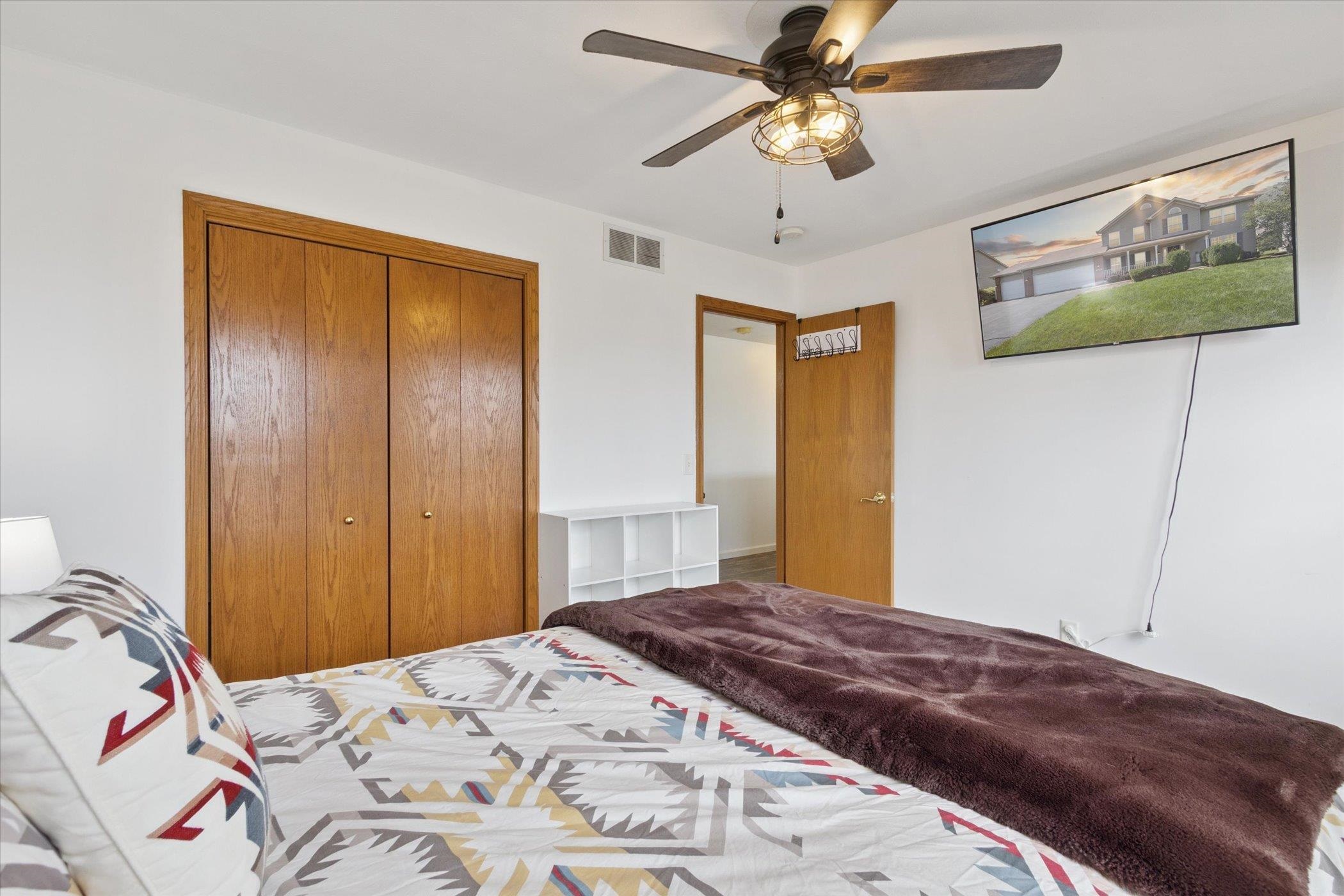 1442 Rock Island Road Davis Junction, IL 61020 - Photo 36 of 63 a bedroom with a bed and a chandelier