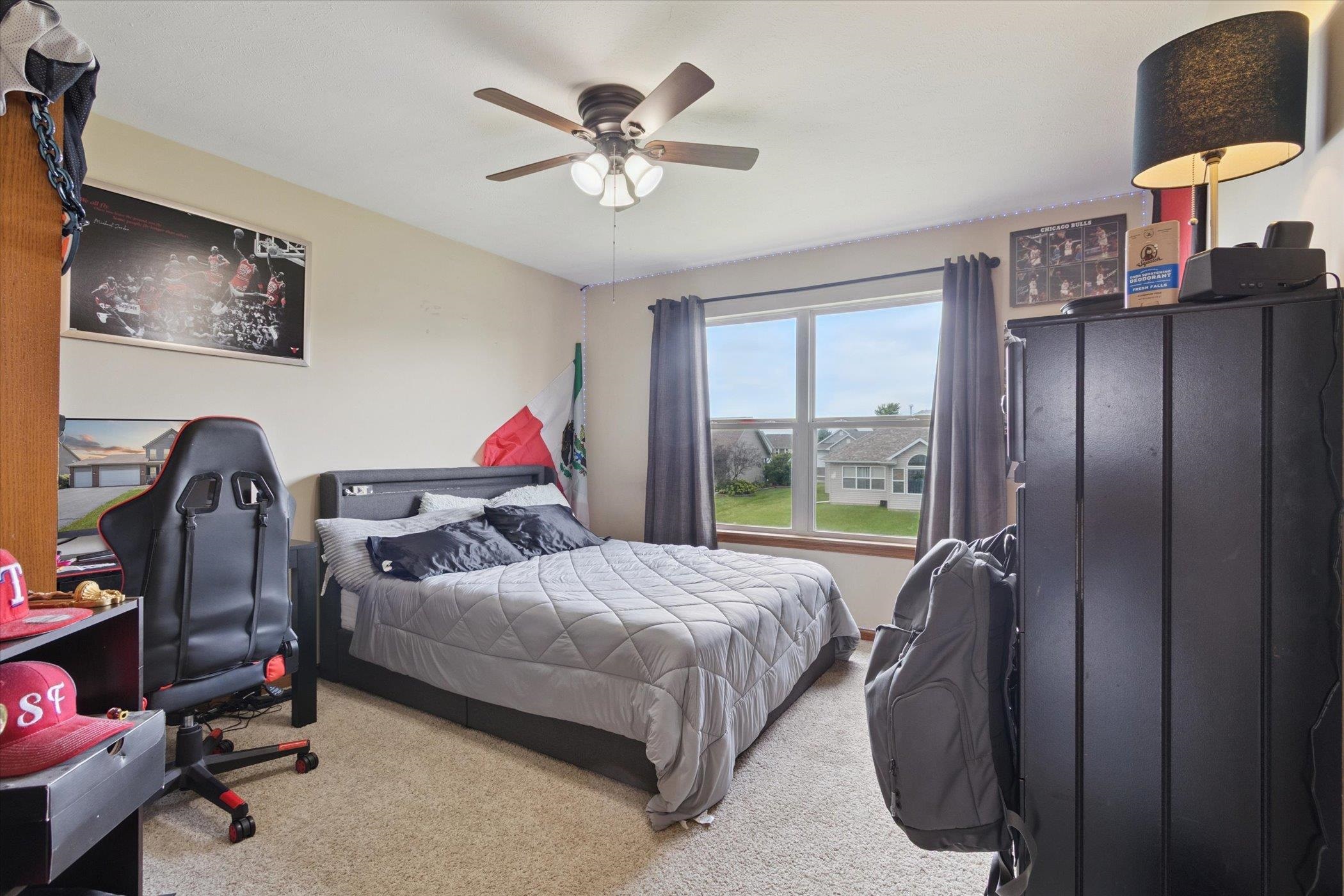 1442 Rock Island Road Davis Junction, IL 61020 - Photo 39 of 63 a bedroom with a bed a chandelier and a window