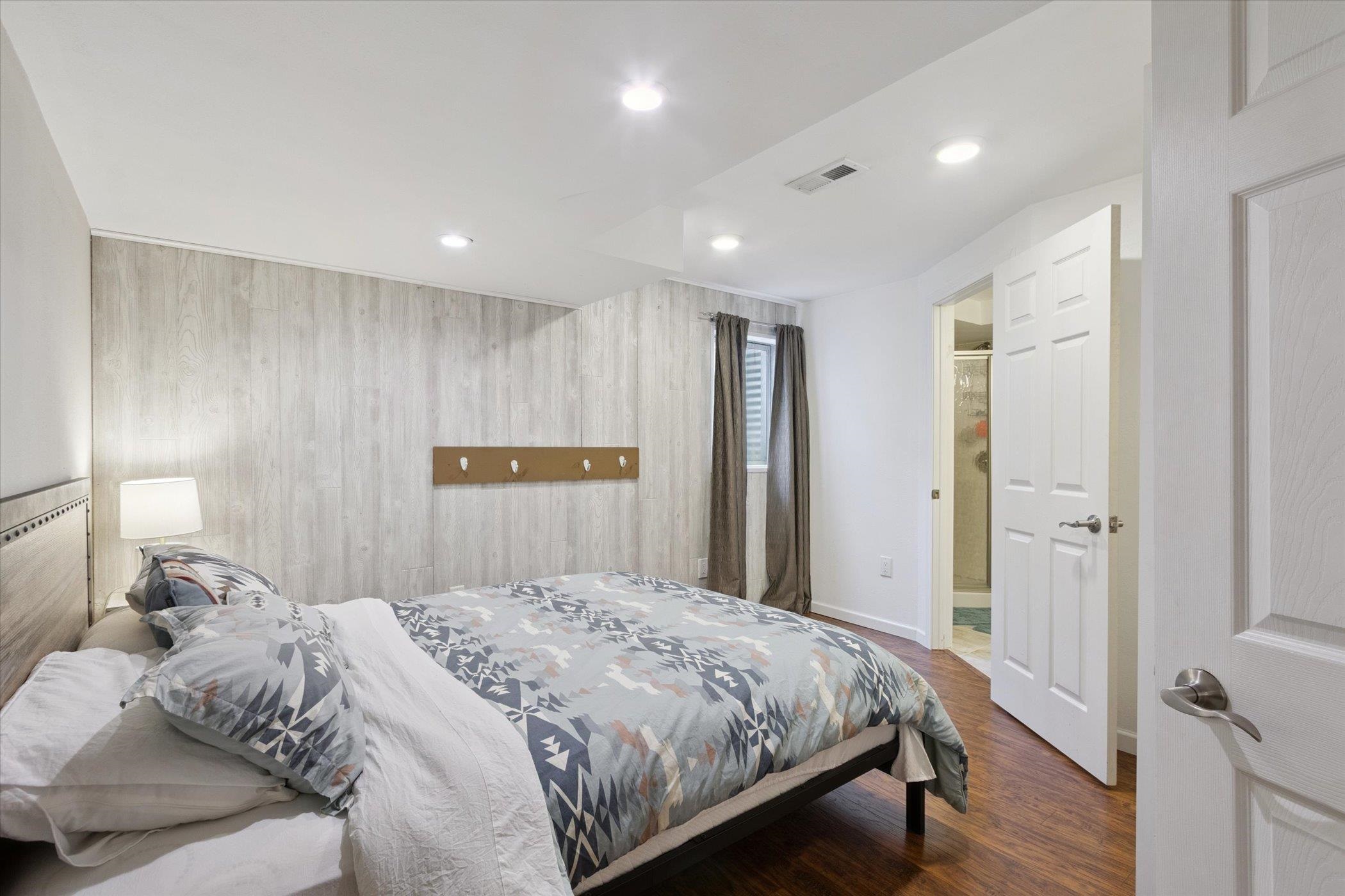 1442 Rock Island Road Davis Junction, IL 61020 - Photo 47 of 63 a bedroom with a large bed and wooden floor
