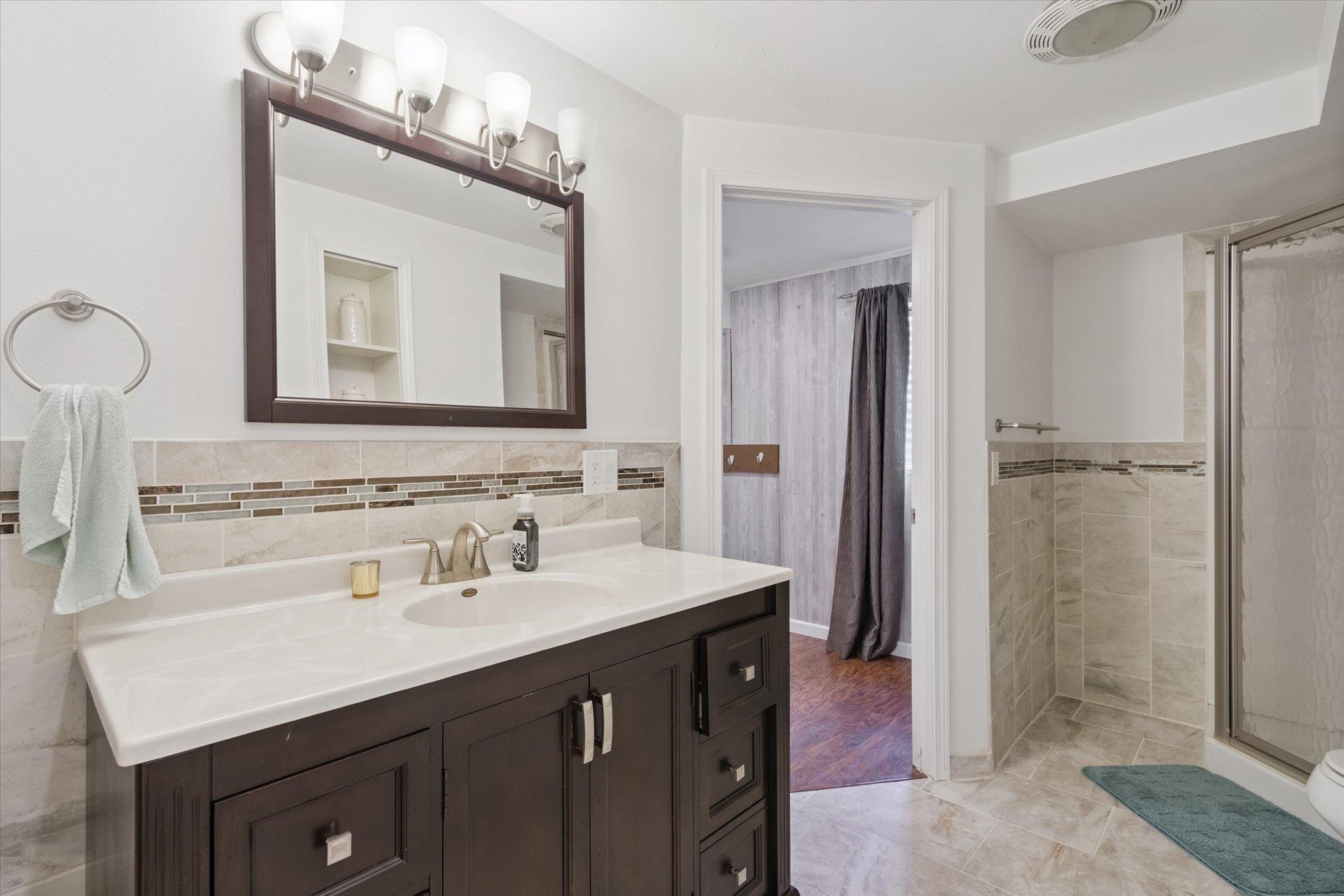 1442 Rock Island Road Davis Junction, IL 61020 - Photo 48 of 63 a bathroom with a sink vanity and a mirror