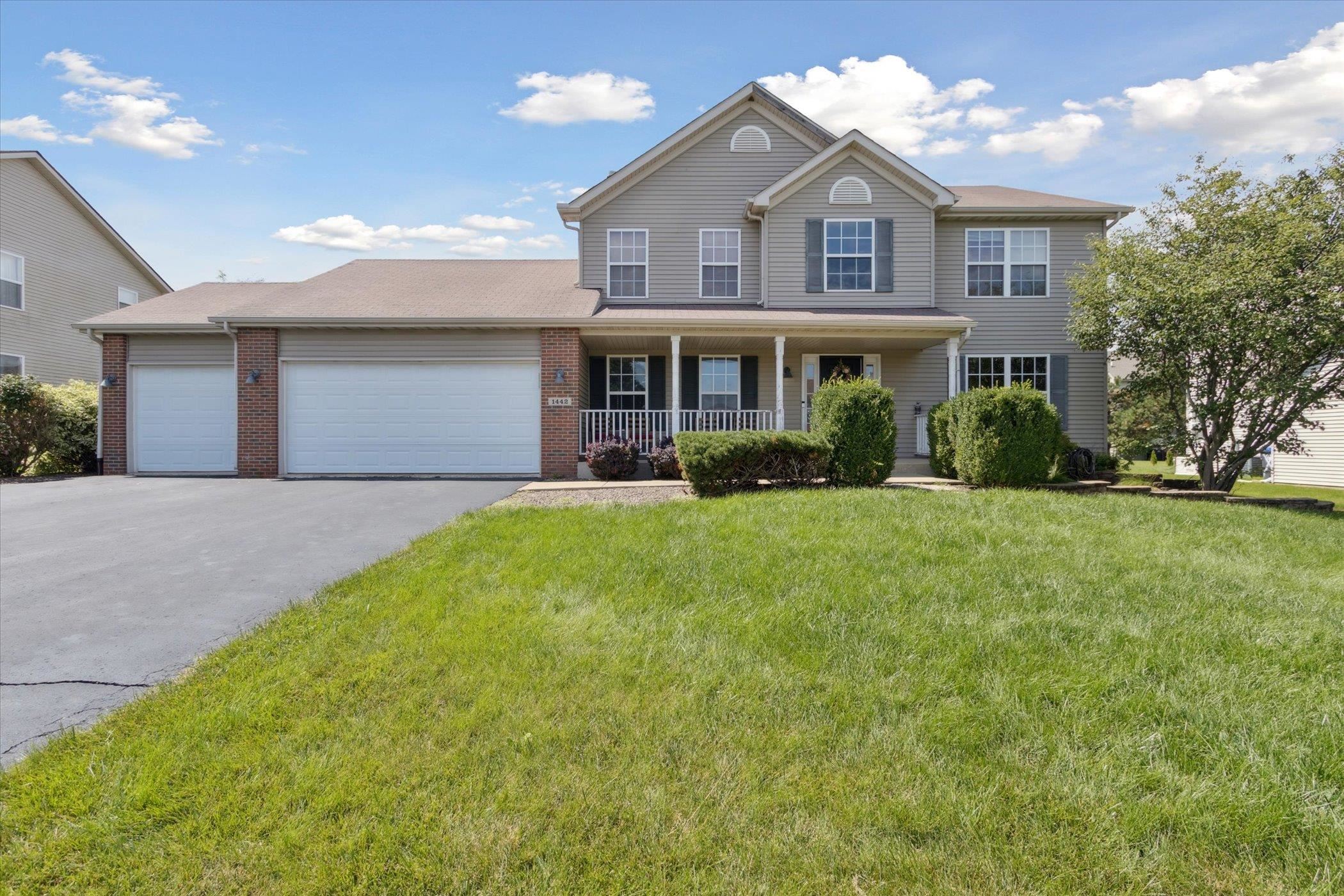 1442 Rock Island Road Davis Junction, IL 61020 - Photo 63 of 63 a front view of a house with a yard and potted plants