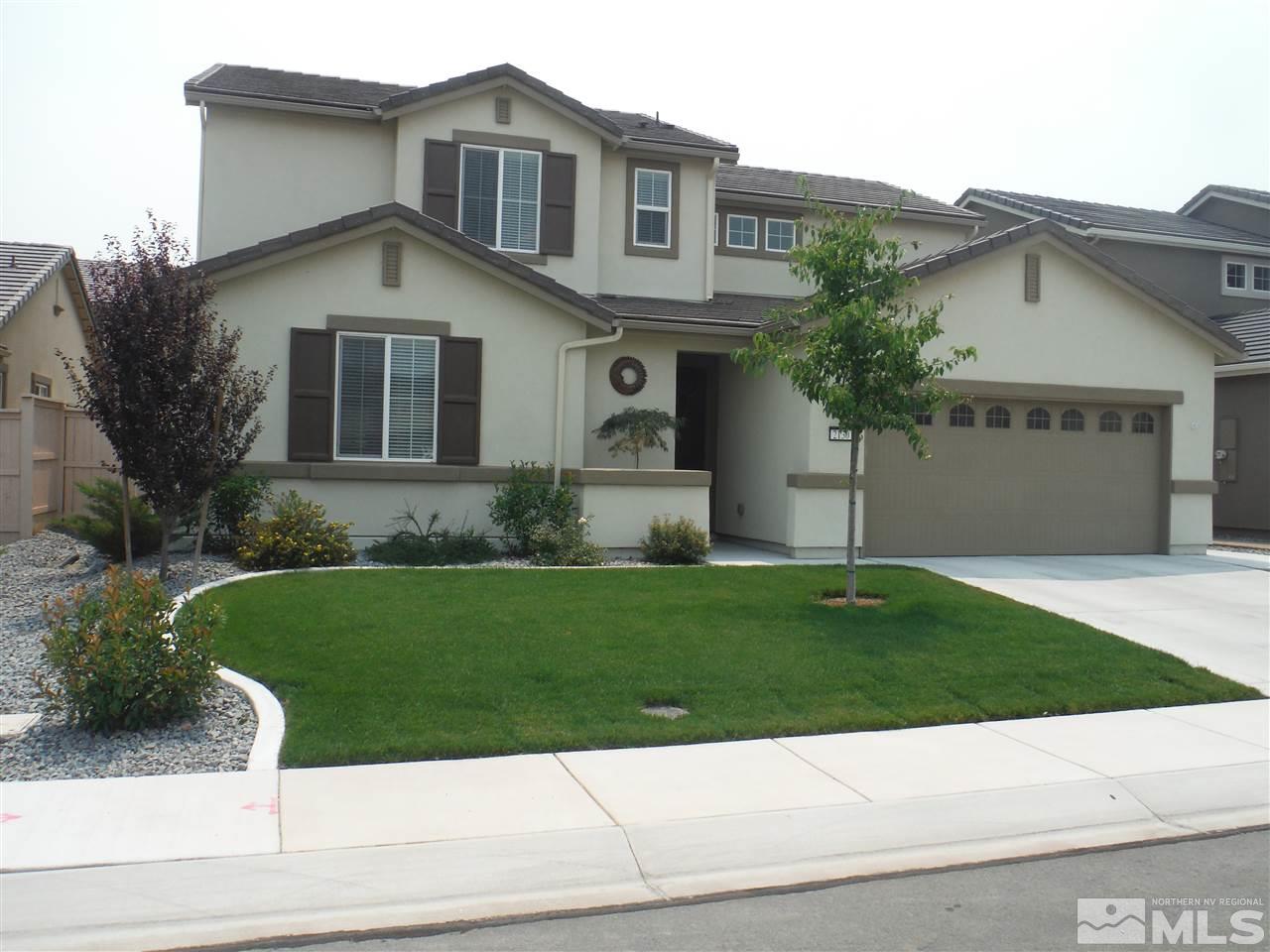 2130 Blue Oaks Drive Reno, NV 89521 - Photo 1 of 20 a front view of a house with a yard and garage
