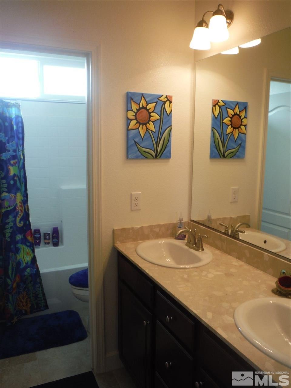 2130 Blue Oaks Drive Reno, NV 89521 - Photo 11 of 20 a bathroom with a granite countertop sink and a mirror