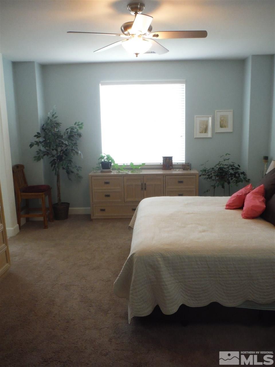2130 Blue Oaks Drive Reno, NV 89521 - Photo 14 of 20 a bed sitting in a bedroom next to a window