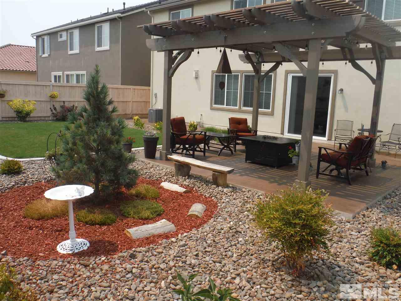 2130 Blue Oaks Drive Reno, NV 89521 - Photo 19 of 20 a front view of a house with a yard fire pit table and chairs