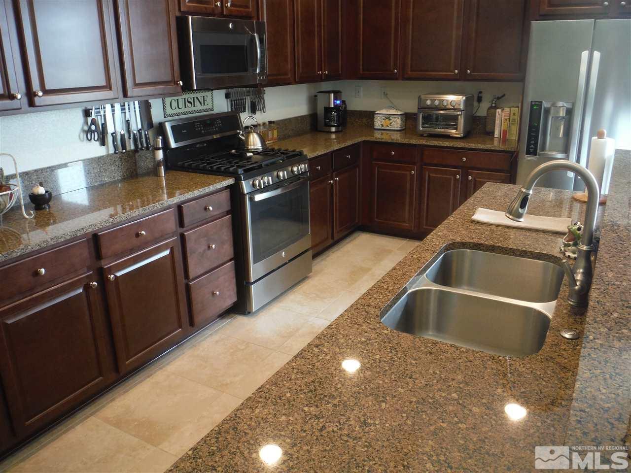 2130 Blue Oaks Drive Reno, NV 89521 - Photo 4 of 20 a kitchen with granite countertop a sink stove and cabinets