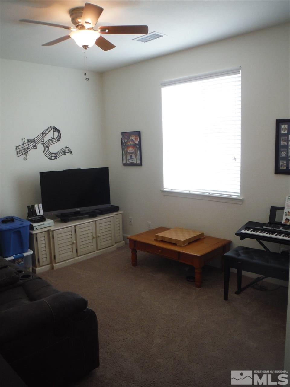 2130 Blue Oaks Drive Reno, NV 89521 - Photo 10 of 20 a living room with furniture and a flat screen tv