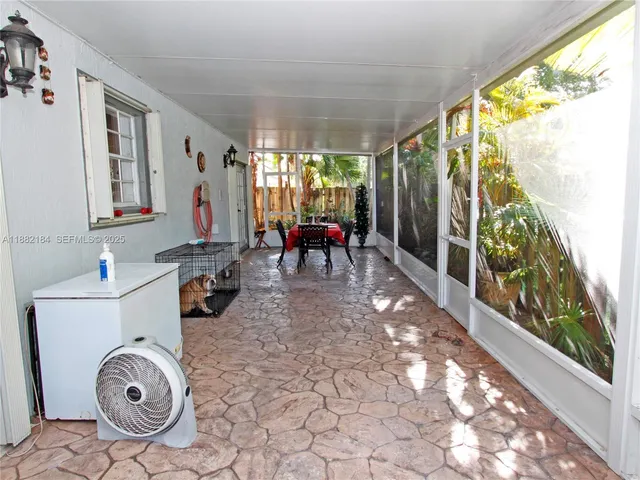 a dining room with furniture a rug and garden view