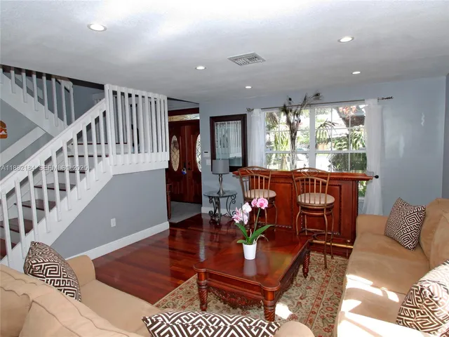 a living room with furniture and a dining table