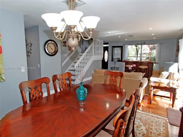 a living room with dining table and a couch