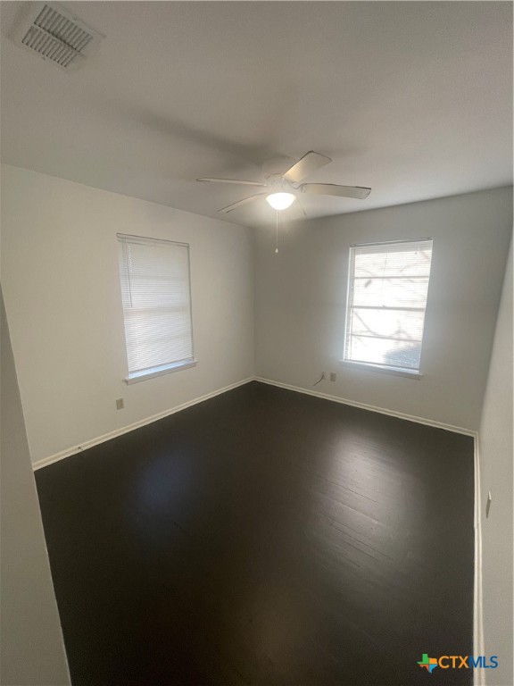 1605 Bexar Avenue Victoria, TX 77901 - Photo 4 of 12 an empty room with wooden floor and windows