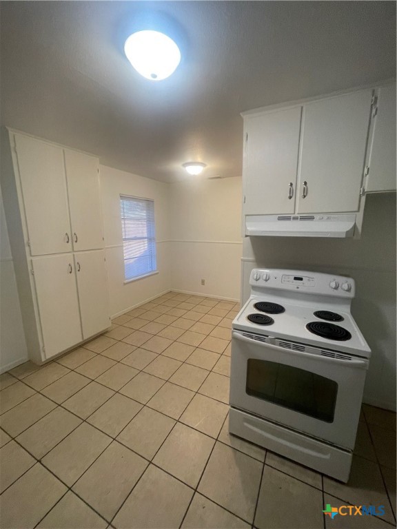 1605 Bexar Avenue Victoria, TX 77901 - Photo 6 of 12 a kitchen with granite countertop white cabinets and white appliances
