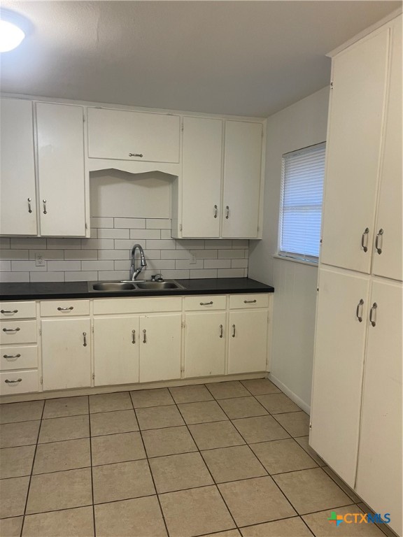1605 Bexar Avenue Victoria, TX 77901 - Photo 7 of 12 a kitchen with cabinets and a stove top oven