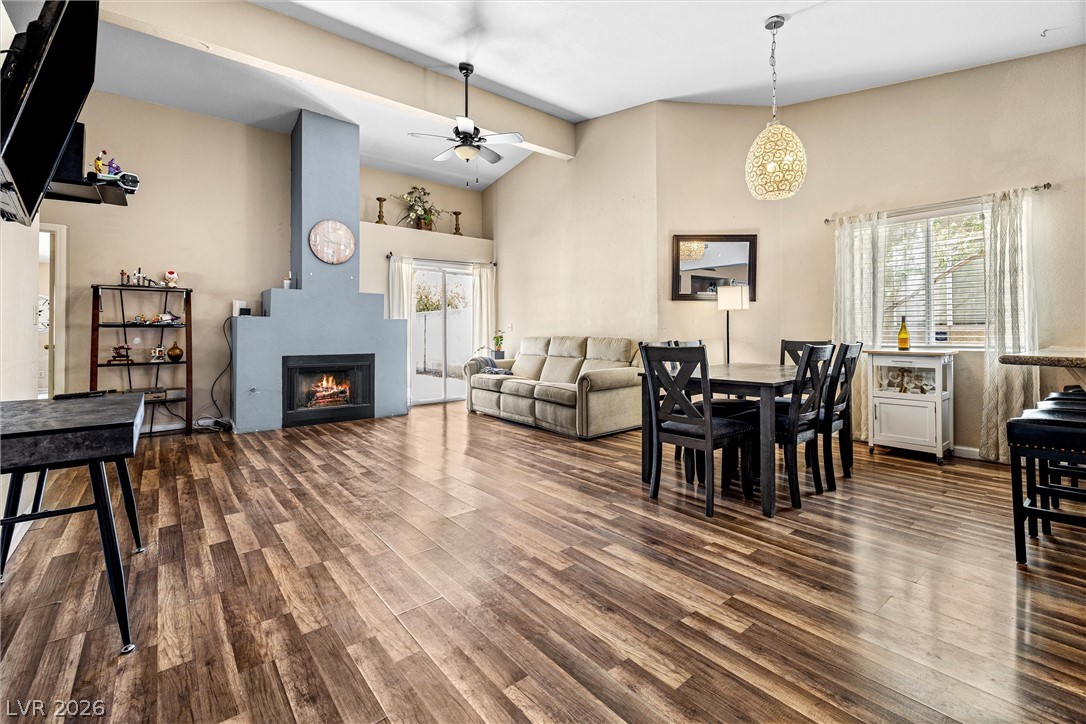 1624 Palmae Way Las Vegas, NV 89128 - Photo 2 of 18 This inviting great room showcases a cozy fireplace and warm wood flooring throughout its spacious layout.