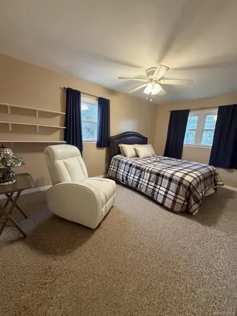 a bedroom with bed and window