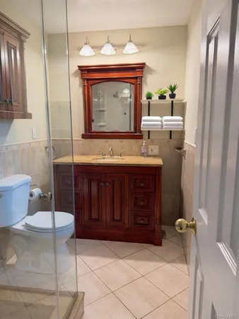 a bathroom with a granite countertop sink a toilet and bathtub