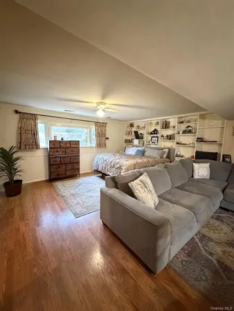 a living room with furniture and view of kitchen