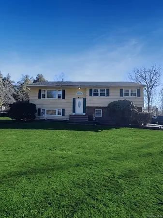 a view of house with outdoor space and yard