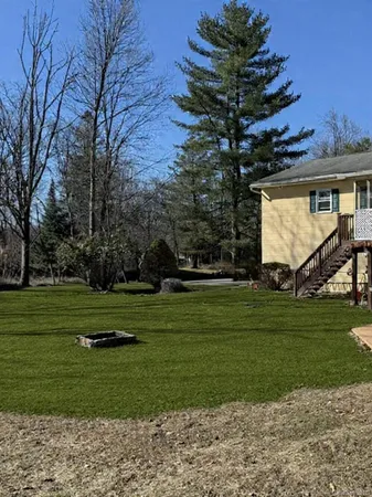 a front view of a house with a yard table and chairs