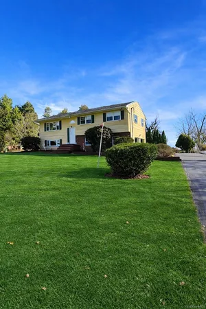 a view of a big house with a big yard