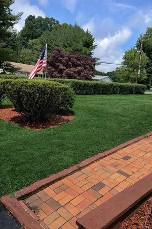 a backyard view with a wooden floor and fence