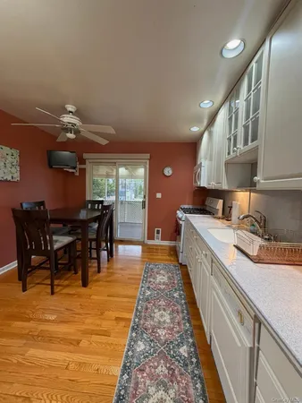 a kitchen with stainless steel appliances granite countertop a dining table chairs and granite counter tops