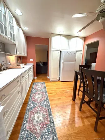 a large white kitchen with a large window