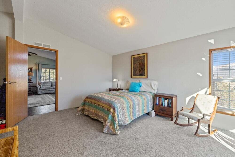 17550 South Poe Valley Road Klamath Falls, OR 97603 - Photo 20 of 59 a spacious bedroom with a bed and a chair