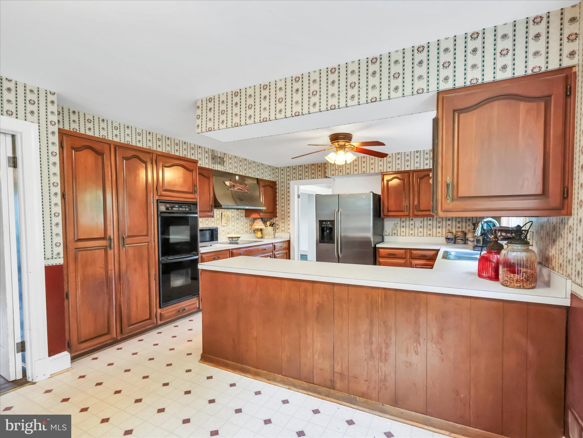 19255 Telegraph Springs Road Purcellville, VA 20132 - Photo 18 of 107 a kitchen with stainless steel appliances kitchen island granite countertop a refrigerator and a stove top oven