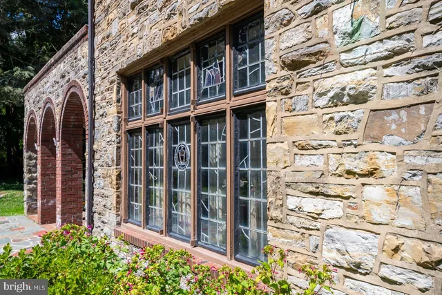 a view of a brick house with many windows