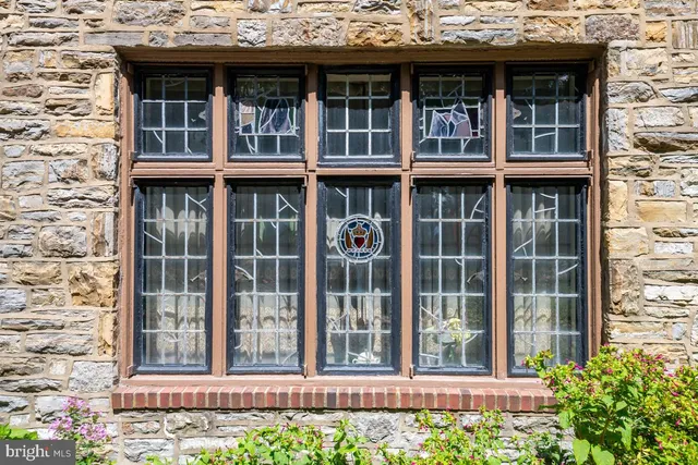 a view of a brick house with large windows
