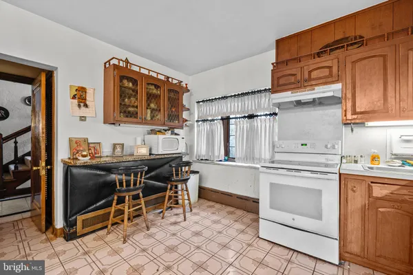 a kitchen with a stove and a refrigerator