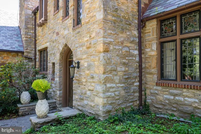 a view of a door of the house with potted plants