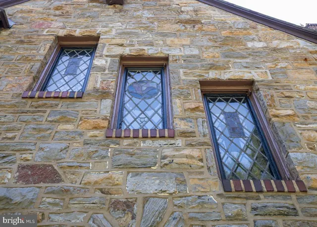 a stone house with a fireplace