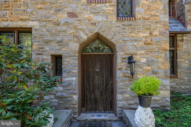 a front view of a house with potted plants