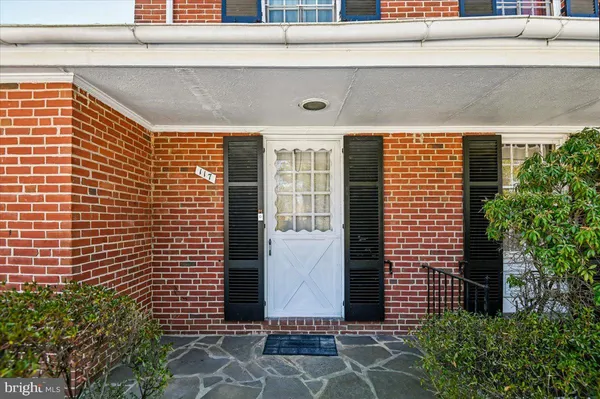 a living room with furniture a rug and a window