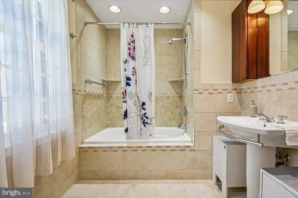 a bathroom with a sink a mirror and a bathtub