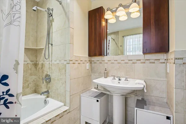 a bathroom with a sink a mirror and a shower