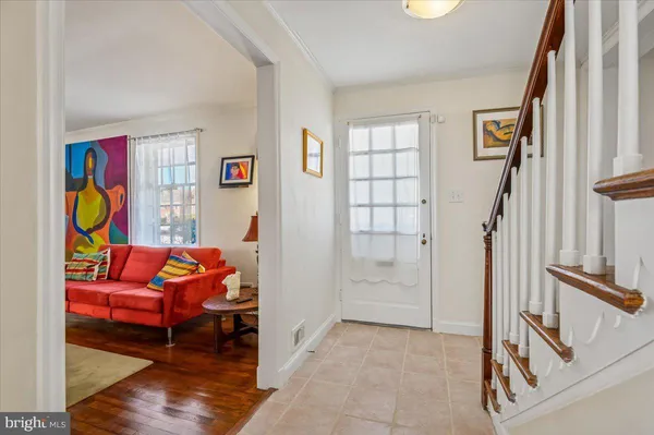 a view of entryway and hall with wooden floor