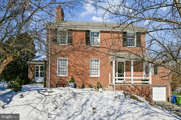 a view of a house with snow on the road