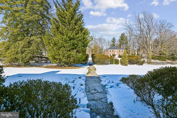 a view of a house with snow on the road