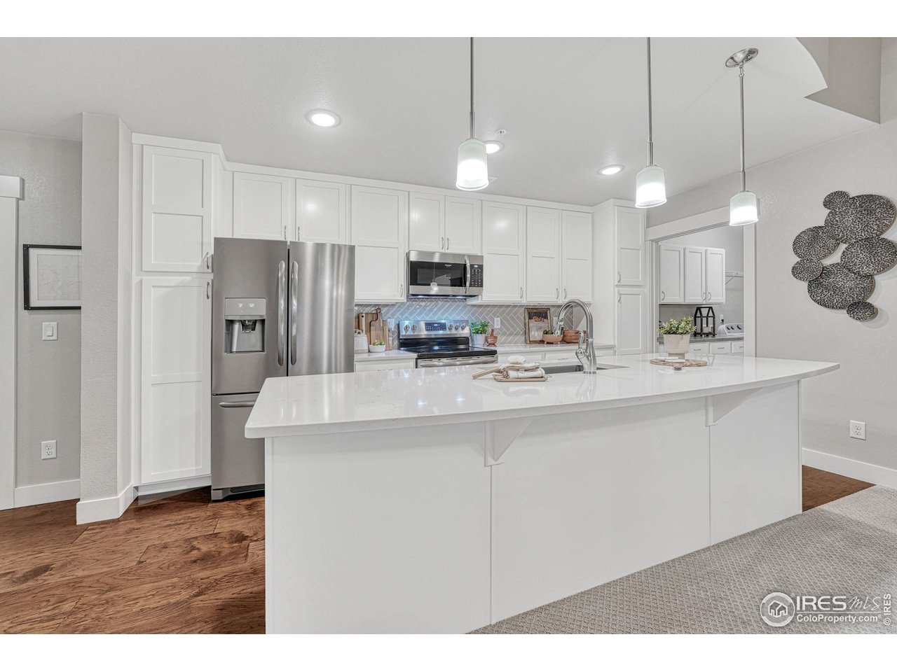 6582 Crystal Downs Drive, Unit 207 Windsor, CO 80550 - Photo 12 of 40 Large kitchen island with room for barstools for eat-in or extra seating.