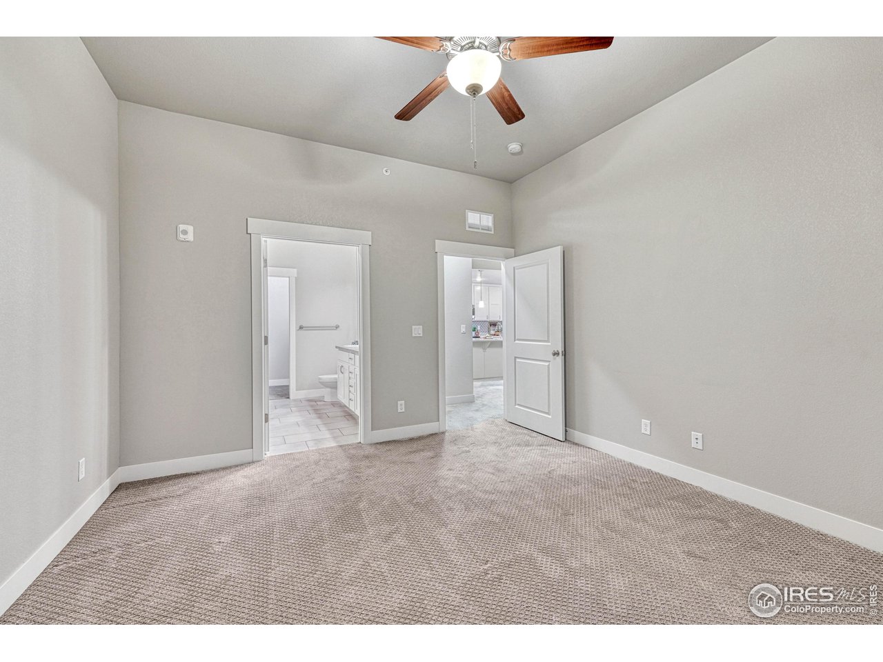 6582 Crystal Downs Drive, Unit 207 Windsor, CO 80550 - Photo 23 of 40 High ceilings with ceiling fan in the primary bedroom