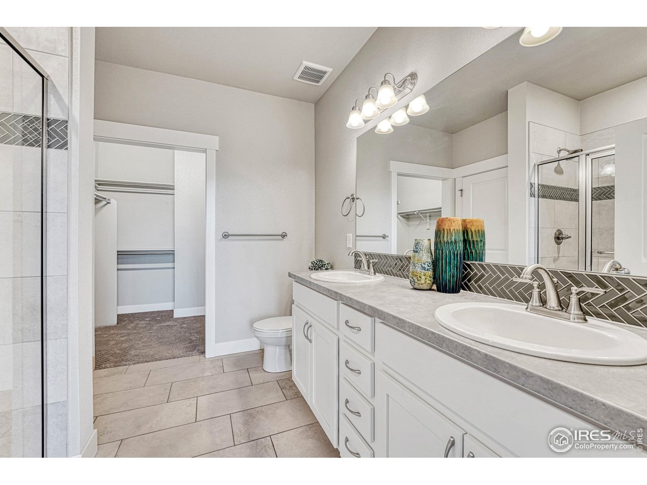 6582 Crystal Downs Drive, Unit 207 Windsor, CO 80550 - Photo 24 of 40 Primary 3/4 bath with double sinks