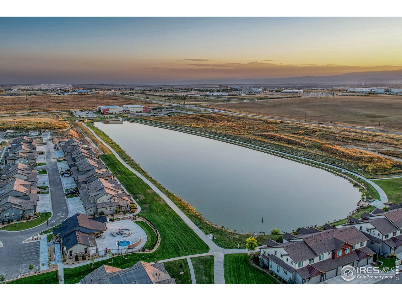 6582 Crystal Downs Drive, Unit 207 Windsor, CO 80550 - Photo 36 of 40 Pond behind clubhouse with a trail all the way around! Power2Play is at the far south end of the pond/lake.