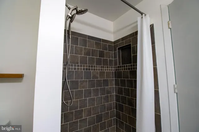 a bathroom with a shower and a mirror