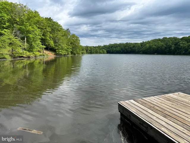 a view of a wooden deck with chairs and a yard