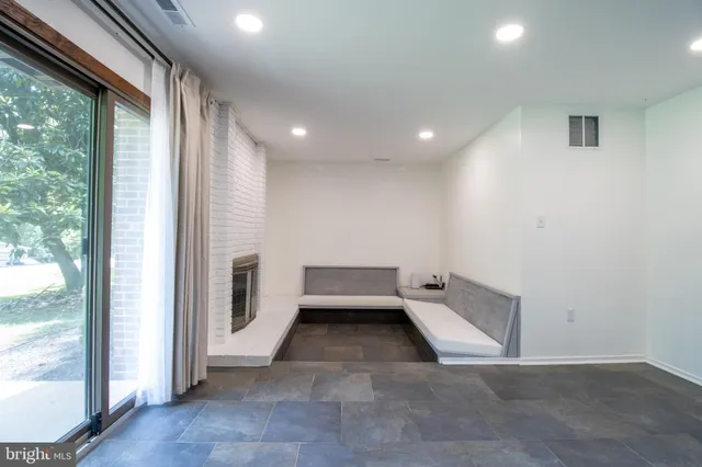 a view of an empty room with a fireplace