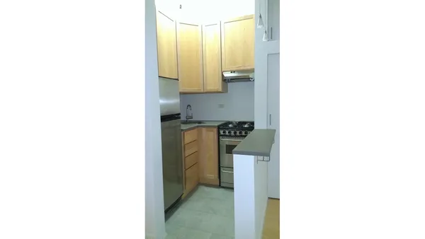 a utility room with a sink and a mirror