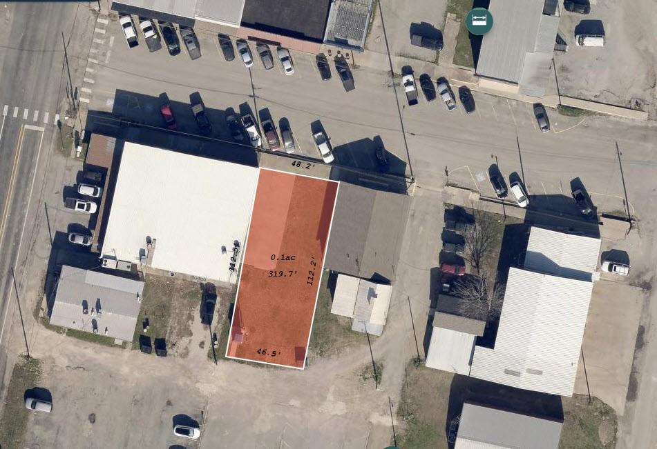 an aerial view of residential house with outdoor space and seating area